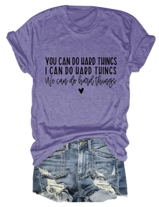 Detailed flat lay of purple graphic t-shirt and distressed denim shorts summer set