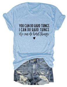 Flat lay of light blue T-shirt with 'You Can Do Hard Things' quote and denim shorts