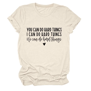 Close-up of inspirational quotes and heart print on a beige round neck cotton t-shirt
