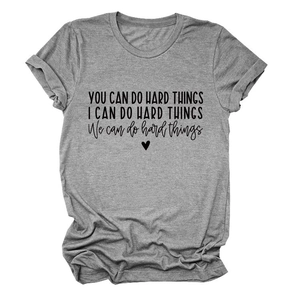 Detail of inspirational quote print and rolled sleeves on a grey crewneck t-shirt