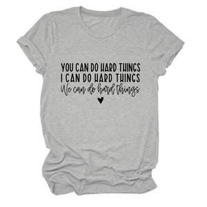 Detail of the inspirational black letter print and heart on a grey crewneck t-shirt