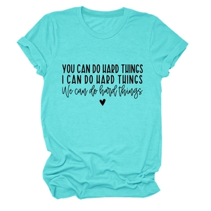 Detail of teal cotton t-shirt featuring black motivational text print and heart icon