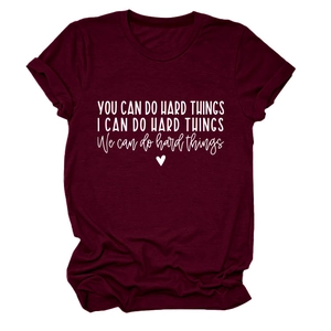 Detail of inspirational white text and heart print on a burgundy cotton t-shirt