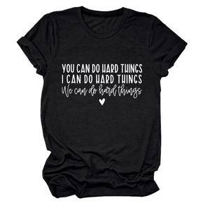 Detail of white motivational text print and heart icon on black cotton t-shirt