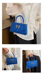Macro shot of bright blue sequin handbag featuring a metallic silver bow detail