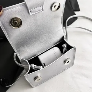Capacity showcase of silver mini crossbody bag holding wireless headphone case