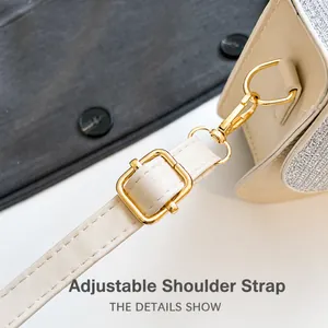 Close-up of adjustable strap with gold hardware and silver sequins on a square bag