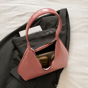 Top view of pink leather handbag on suit showing internal space for daily essentials