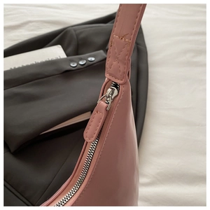 Close-up of pink shoulder bag zipper detail with neat stitching and silver hardware