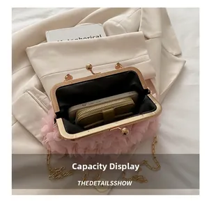 Capacity display of the pink pleated floral clutch showing phone and wallet inside