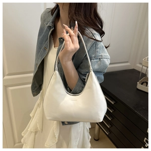 White leather hobo bag with Fashion embossing shown in a lifestyle setting