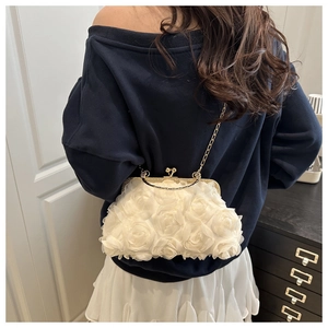 Elegant white evening bag with 3D mesh roses and gold chain shown on a model