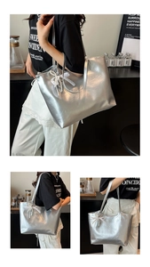Detail of silver metallic tote bag with lace bow and pearl charm decorations