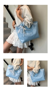 Close-up of light blue tote bag with decorative lace bow and pearl chain details