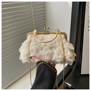 Detail of white 3D floral evening bag with delicate chiffon roses and gold metal handle