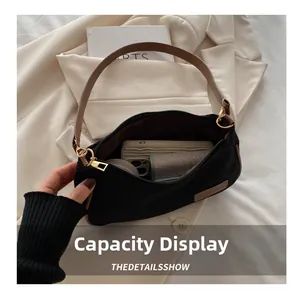 Practical interior capacity of black fabric underarm bag with leather trim and gold buckle