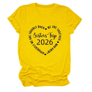 Détail du graphisme Sisters' Trip 2026 en forme de cœur noir sur un T-shirt coton jaune