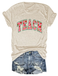 Flat lay of cream cotton t-shirt with Teach strawberry print and distressed denim shorts
