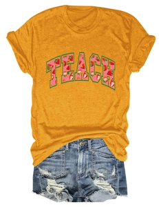 Close-up of TEACH strawberry print on yellow cotton t-shirt with denim shorts