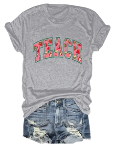 Detailed flat lay of grey Teach t-shirt with strawberry print and ripped denim shorts