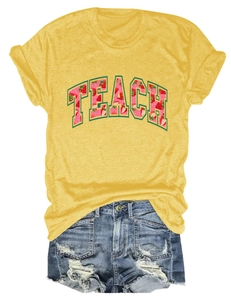 Flat lay of yellow t-shirt with TEACH strawberry print and distressed denim shorts