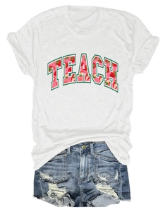 Close-up of a white Teach t-shirt with strawberry graphic paired with denim shorts