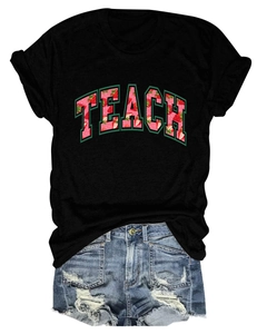 Close-up of black cotton t-shirt with pink floral strawberry TEACH print and denim shorts