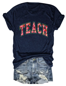 Detail of TEACH strawberry print on navy blue cotton T-shirt with frayed denim shorts