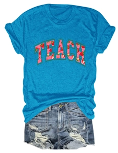 Detail of TEACH strawberry print on blue cotton T-shirt with frayed denim shorts