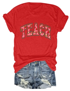 Detail of red TEACH cotton t-shirt with strawberry print and distressed denim shorts