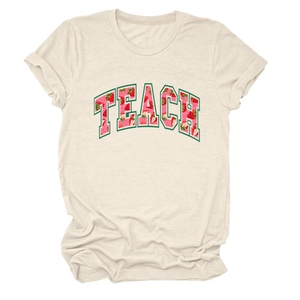 Detailed view of the strawberry pattern within TEACH lettering on ivory cotton T-shirt