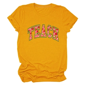Close-up of ginger yellow crew neck T-shirt featuring TEACH strawberry floral lettering