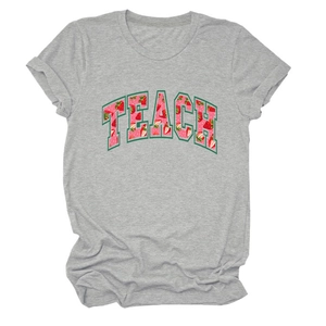 Close-up of TEACH strawberry print and rolled cuff on a grey cotton blend T-shirt