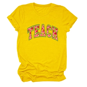Close-up of strawberry-textured TEACH print on yellow crew neck short sleeve T-shirt