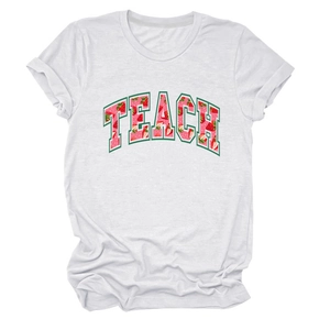 Detailed view of strawberry pattern within TEACH lettering on white cotton T-shirt
