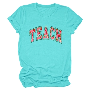 Close-up of teal cotton t-shirt featuring TEACH text with strawberry pattern print