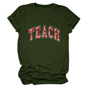 Detail of dark green t-shirt featuring TEACH letter print with strawberry pattern