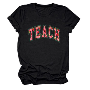 Close-up of black cotton T-shirt featuring TEACH letter print with strawberry graphic