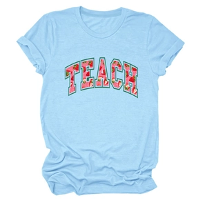 Close-up of the strawberry-filled TEACH print on this light blue cotton crewneck T-shirt