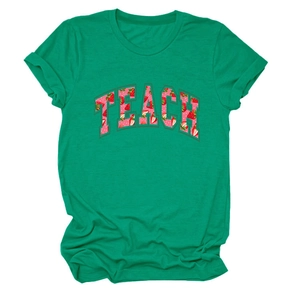 Detail of green cotton t-shirt featuring strawberry pattern letters with TEACH print