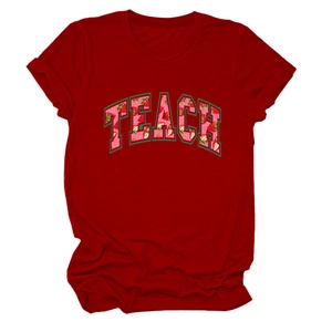 Close-up of the strawberry-filled TEACH print on a dark red round neck cotton T-shirt