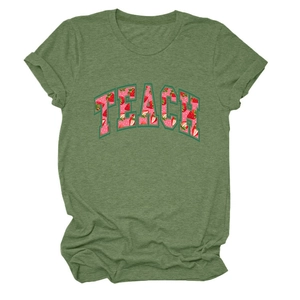 Close-up of TEACH letter print with strawberry pattern on green short sleeve T-shirt