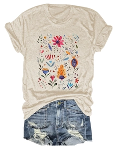 Flat lay of beige floral t-shirt paired with distressed blue denim shorts and fringe detail