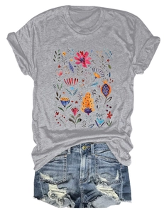 Close-up of bohemian floral print on gray T-shirt with distressed denim shorts