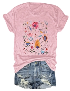 Close-up of vibrant floral watercolor print on pink crew neck short sleeve t-shirt