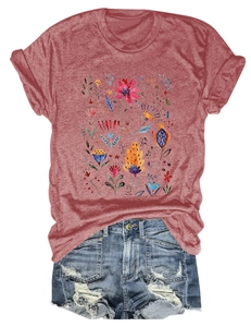 Close-up of floral print crewneck t-shirt in rust red with distressed denim shorts