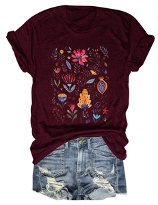 Detailed view of floral print on wine red t-shirt paired with frayed denim shorts
