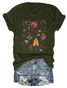 Flat lay of casual green t-shirt with red floral print and distressed denim shorts