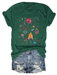 Detailed close-up of floral watercolor print on dark green short sleeve T-shirt with denim shorts