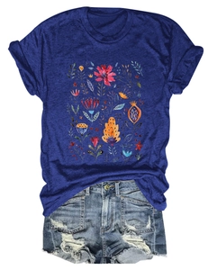 Detailed view of floral print on dark blue cotton T-shirt with distressed denim shorts
